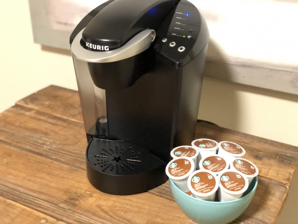 Keurig coffee maker with coffee pods provided.\