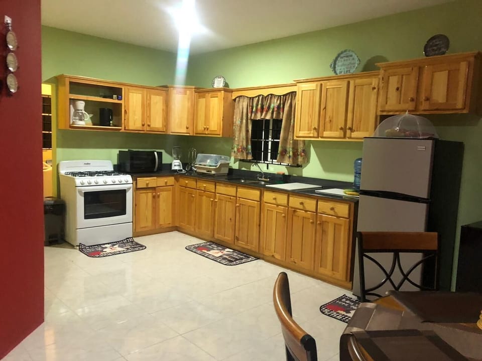 Full kitchen features 6 burner gas stove, refrigerator, microwave, dining table