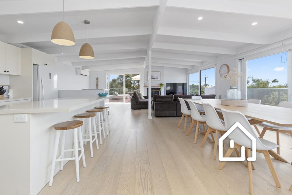 Open plan kitchen, dining and living, showcasing panoramic bay views