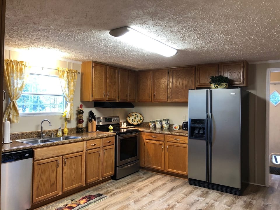 Kitchen with refrigerator, oven/range, and dishwasher