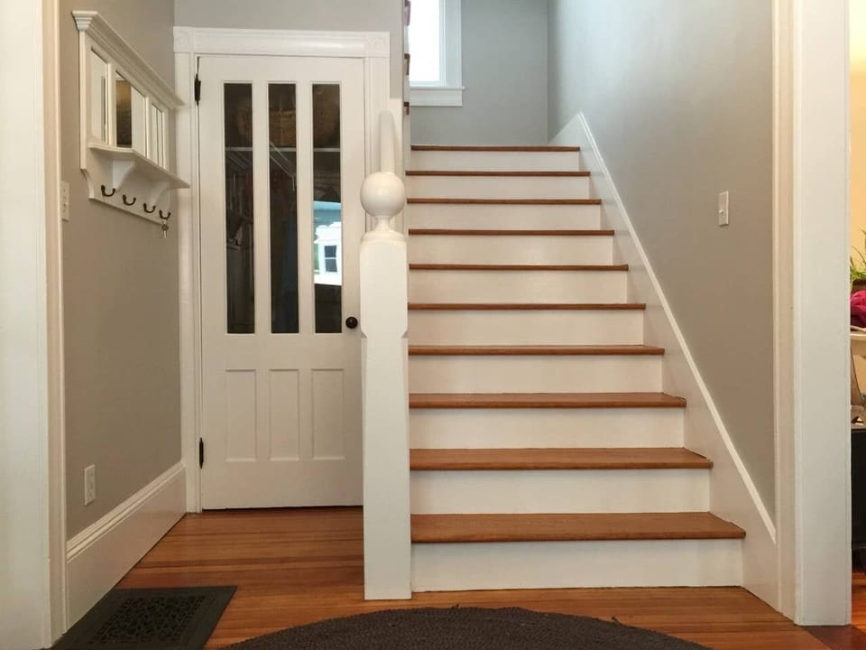View of entry coat hooks, coat closet and stairs to 2nd floor.