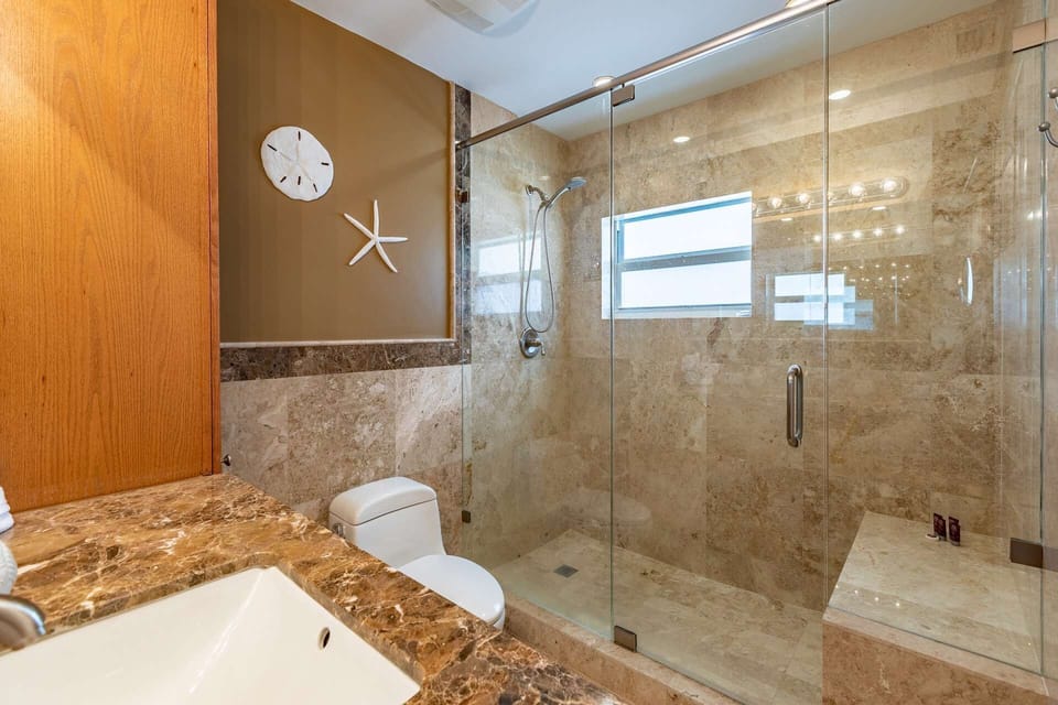 The en-suite bathroom features a beautiful glass and tile shower for your convenience.