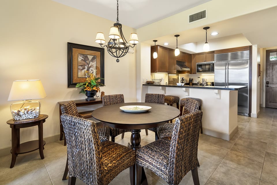 Dining area with wicker chairs and high table.