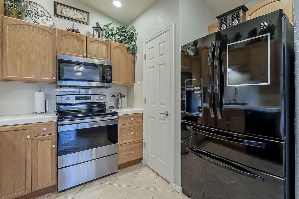 A dreamy full kitchen anchored by a with a large, indulgent fridge, perfect for cooking and gathering. 