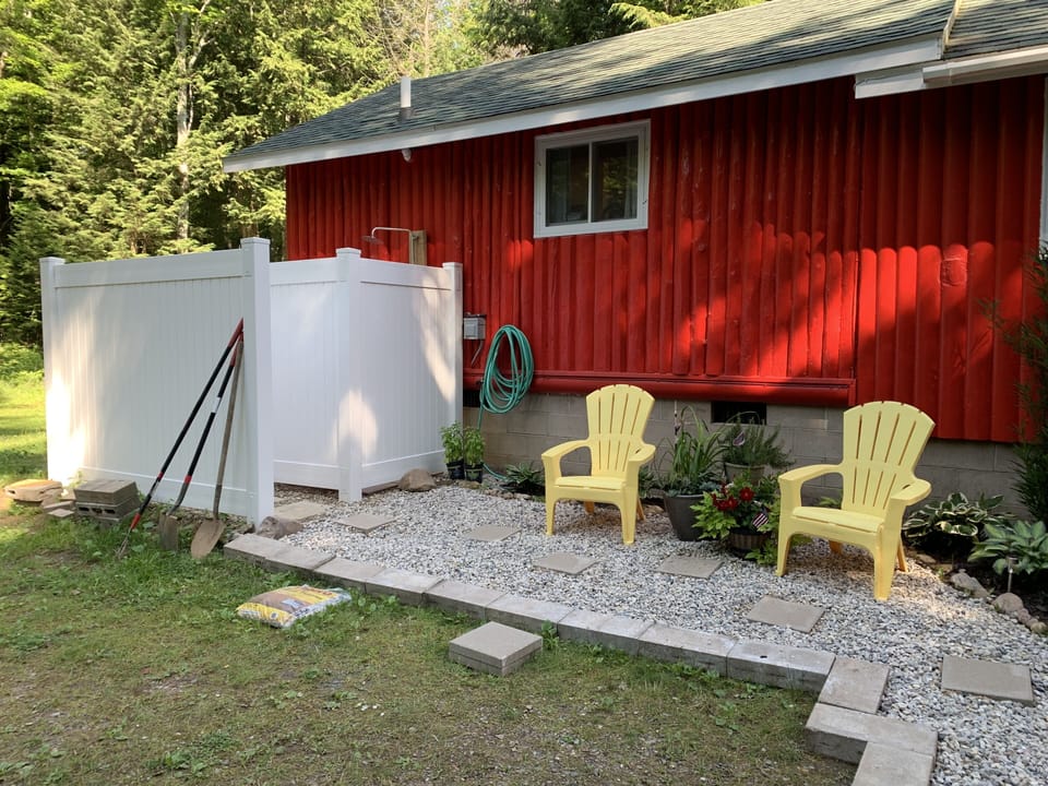 Outdoor wash station for a rinse after a long day at the lake, plenty of hooks