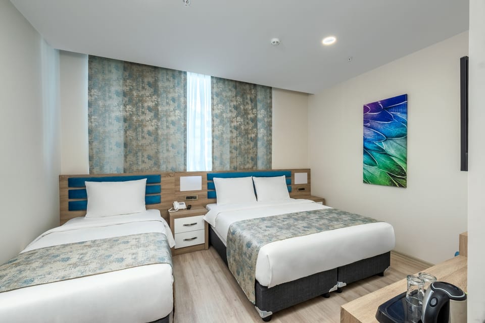 Family Room, Multiple Beds | Premium bedding, down comforters, minibar, individually decorated