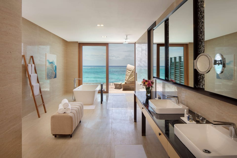 Presidential three bedroom over water pool villa with free access to VIP seaplane lounge on arrival | Bathroom | Separate tub and shower, rainfall showerhead, eco-friendly toiletries
