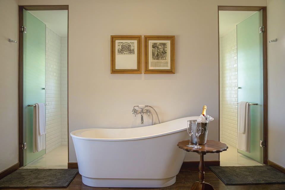 Executive Suite, 1 Double Bed | Bathroom | Rainfall showerhead, hair dryer, bathrobes, slippers