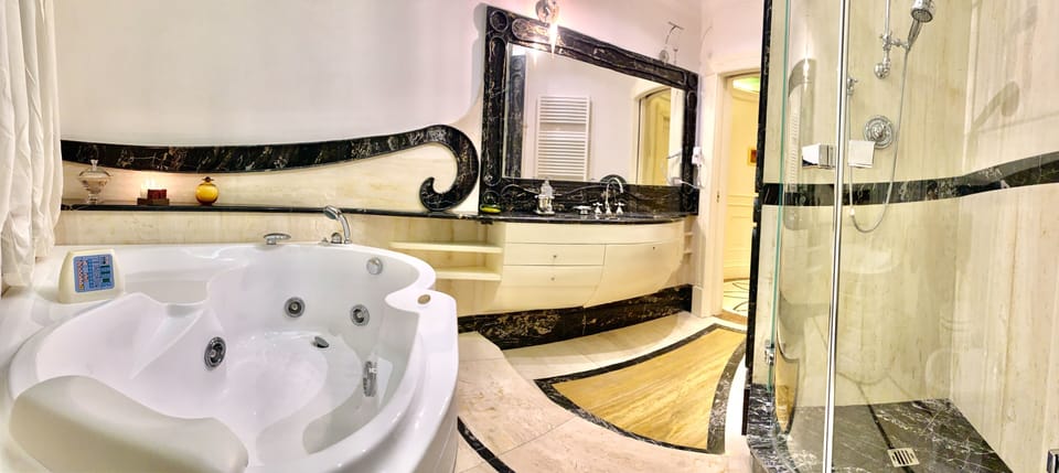 Deluxe Suite, Jetted Tub | Bathroom | Hair dryer, towels, soap, shampoo