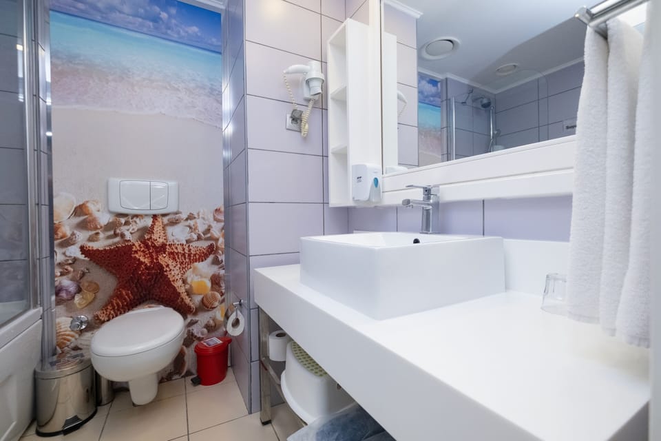 Standard Room, Multiple Beds | Bathroom | Shower, eco-friendly toiletries, hair dryer, slippers