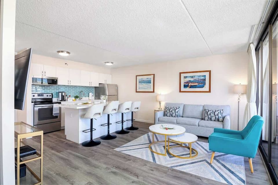 Modern open-concept living area with a fully equipped kitchen and bright seating space.