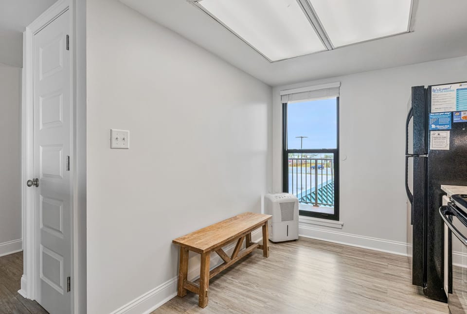 Fully equipped kitchen with white cabinets and breakfast bar at Wind Drift 209 SW