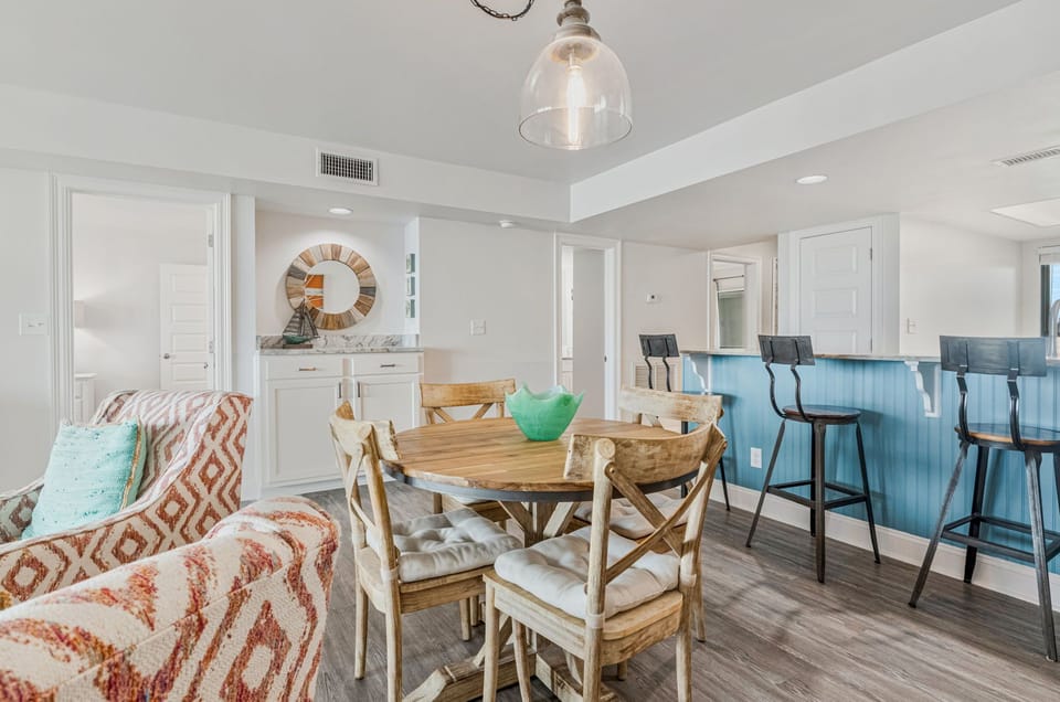 Fully equipped kitchen with white cabinets and breakfast bar at Wind Drift 209 SW