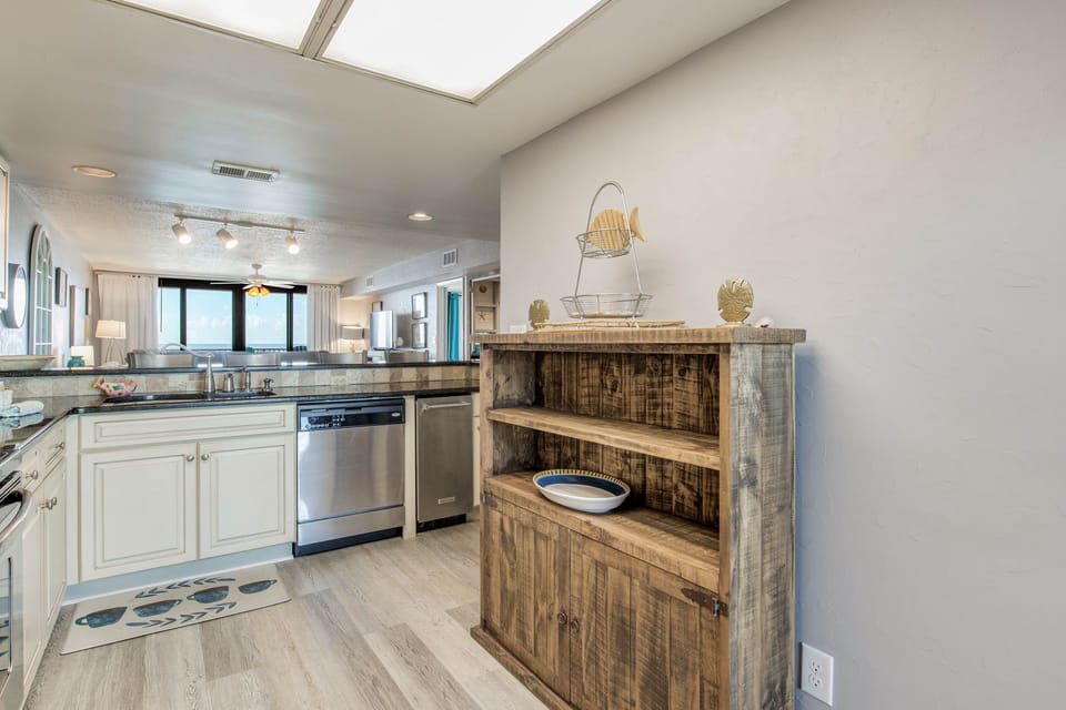 Kitchen with white cabinetry and ample counter space at Orange Beach Wind Drift
