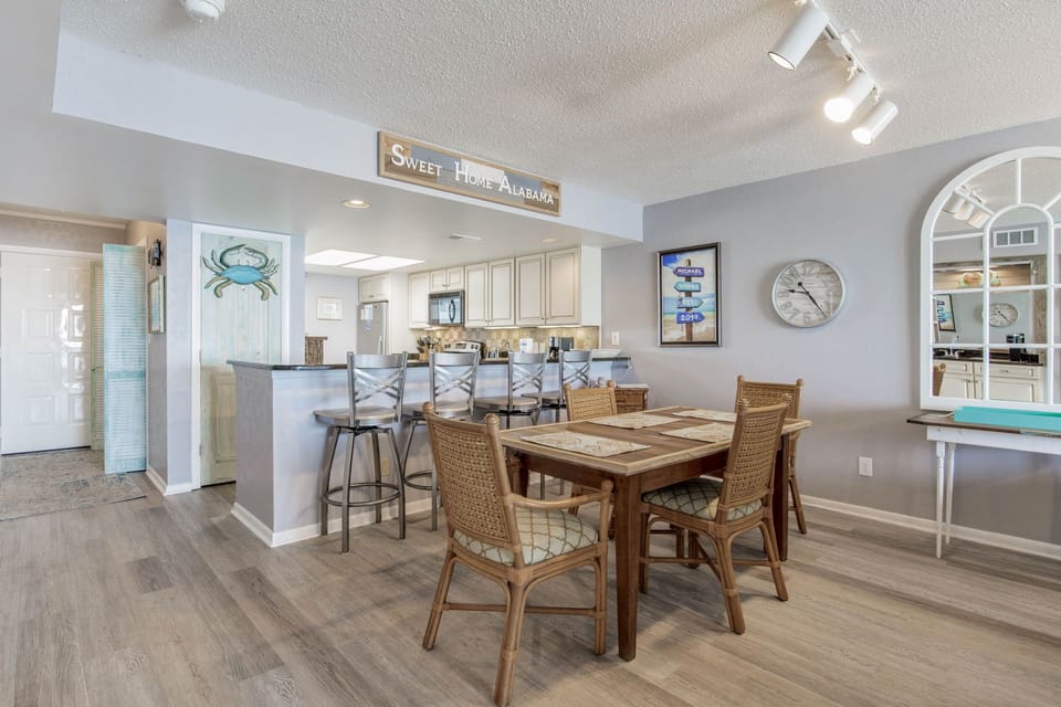 Dining area with table seating 6 and breakfast bar at Wind Drift