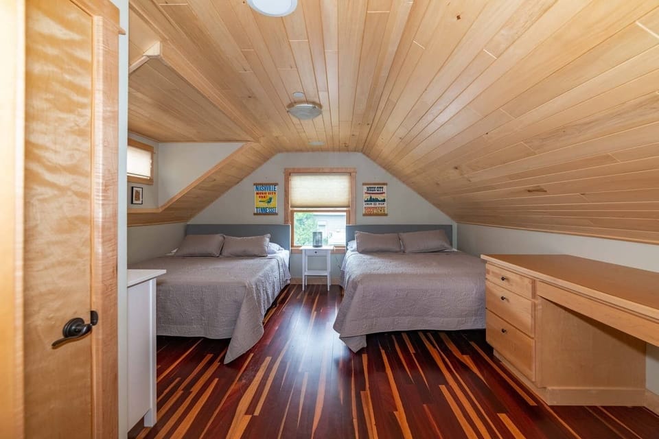 Additional upstairs bedroom with two queen beds and a built-in desk.