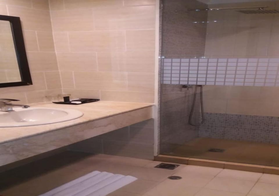 Shower, rainfall showerhead, designer toiletries, slippers