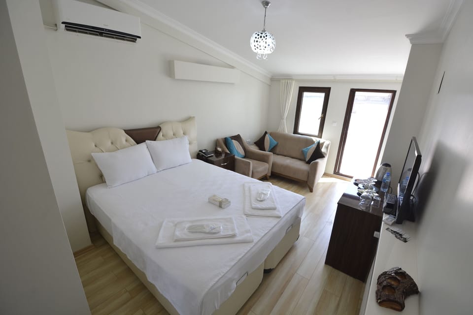 Standard Triple Room | Minibar, desk, laptop workspace, blackout drapes