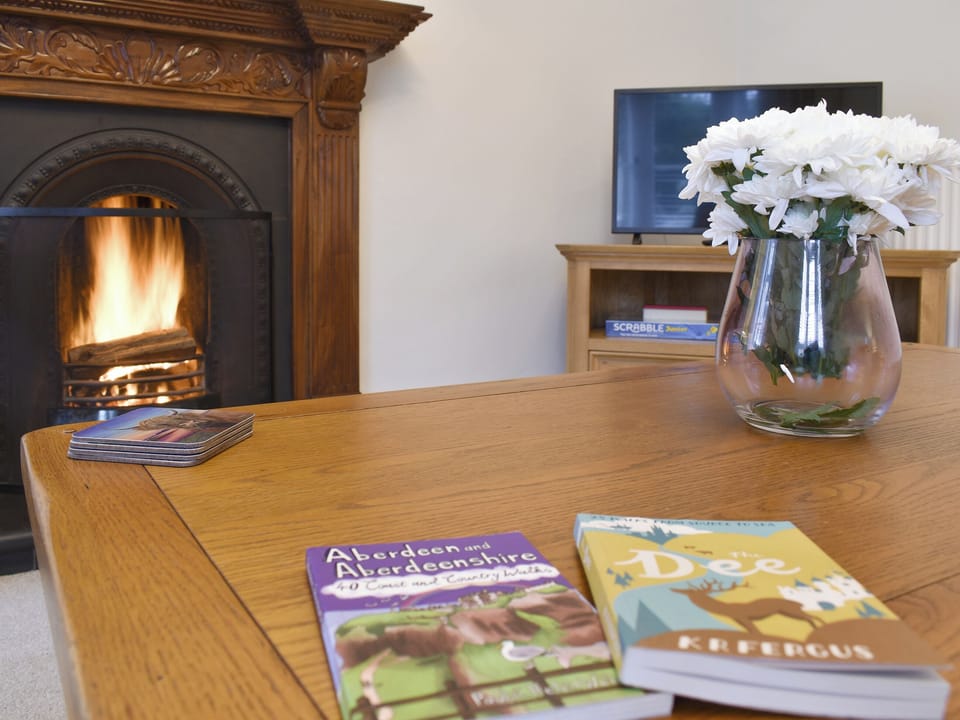 Welcoming living room with open fire | West Lodge, Banchory