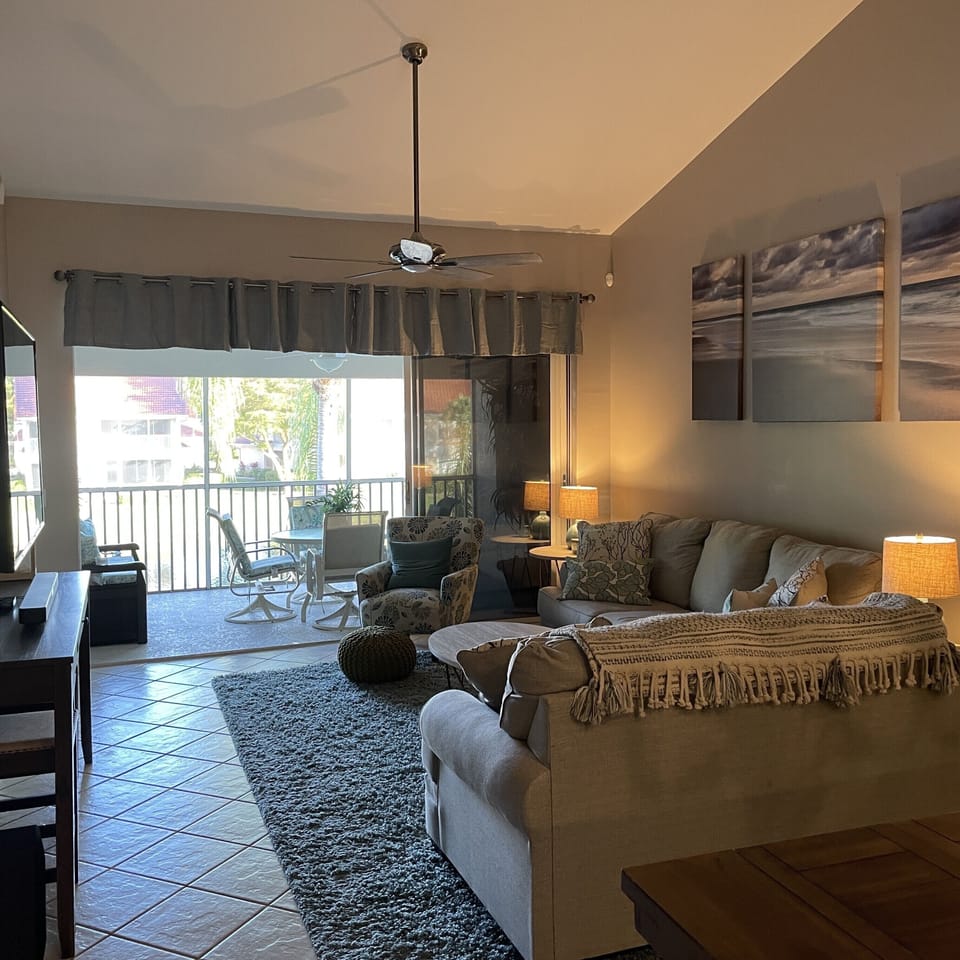 Living area opens to screened lanai overlooking fountain lake 