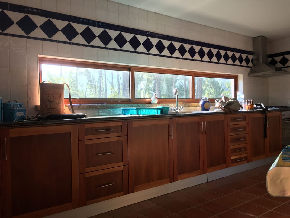 View of the Kitchen, Kitchen equipped with a fridge, a stove, oven.