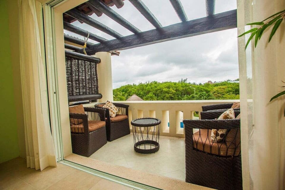 The balcony overlooks the pool and neighbouring mangrove.