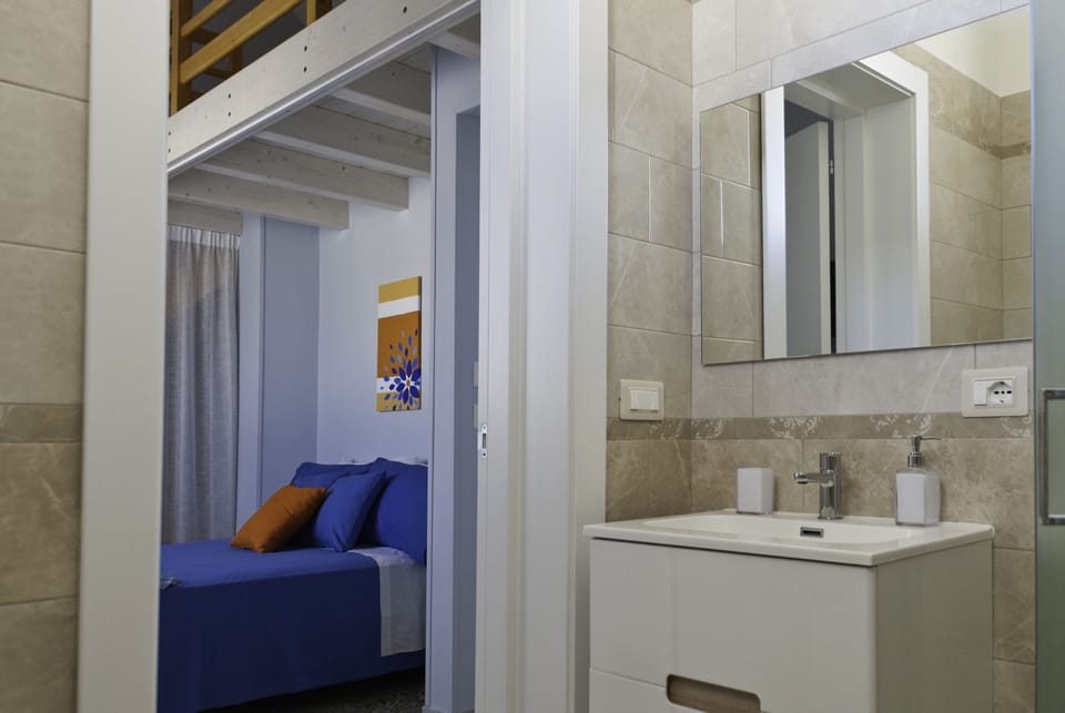 Double Room (Topazio) | Bathroom | Shower, rainfall showerhead, hair dryer, bathrobes