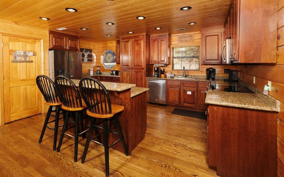 Fully-equipped kitchen with bar seating - perfect for cabin cookouts!