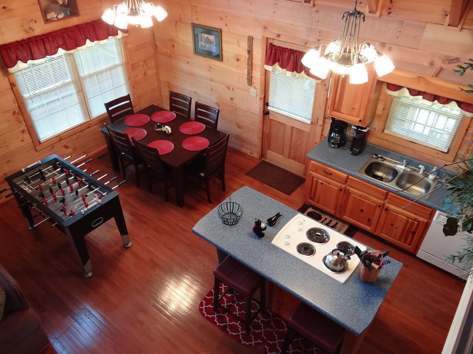 Viewing kitchen & dining table, including a Foosball table, from the loft area.
