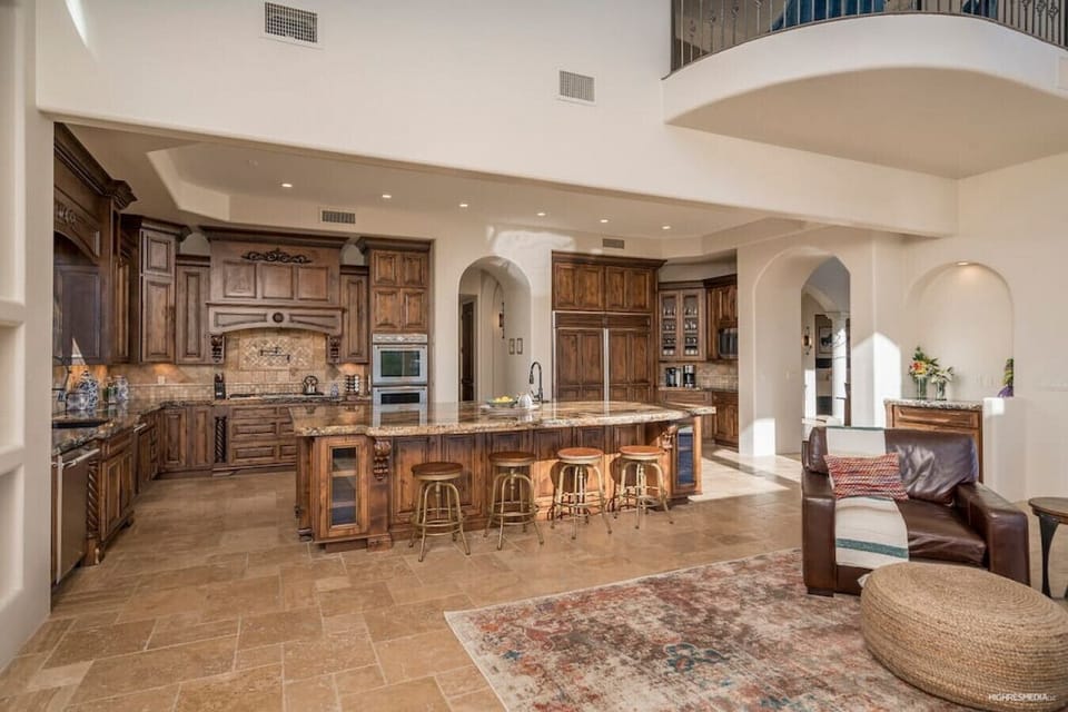 [Kitchen] Fully equipped with double ovens, gas cooktop, and large center island with seating