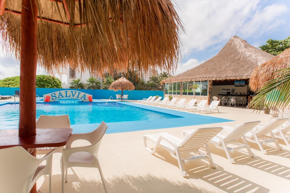Relax by the pool with a refreshing piña colada from the bar.