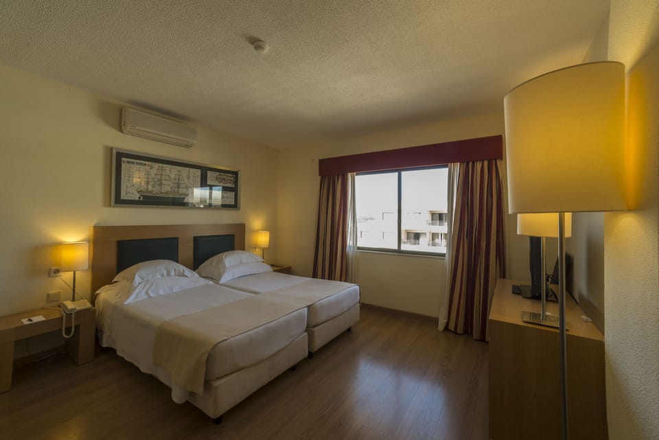 Standard Twin Room, Pool View | Minibar, in-room safe, desk, blackout drapes