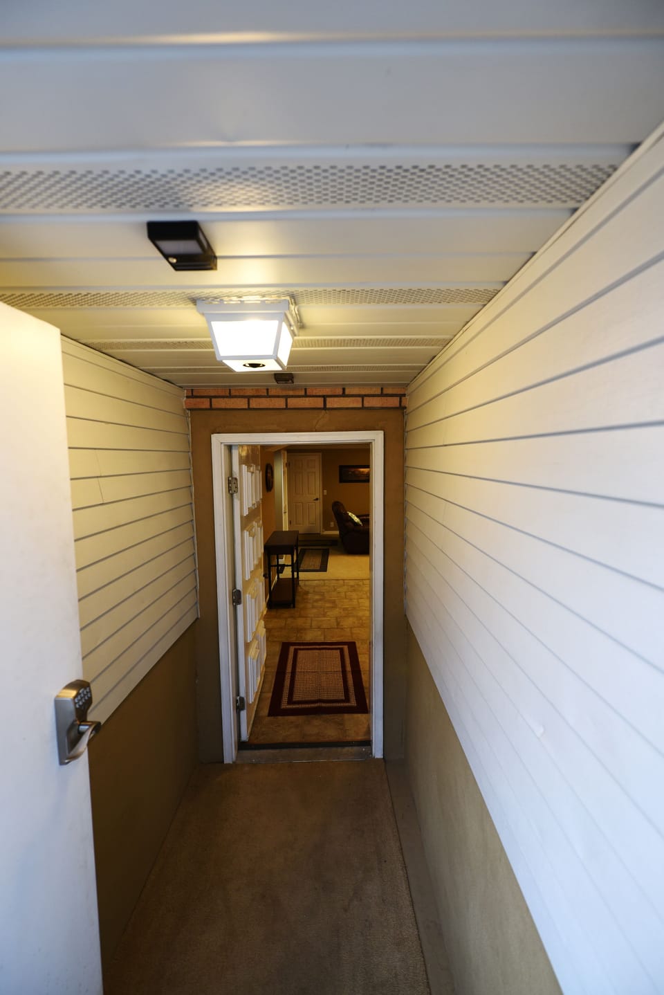 Three steps down to motion-lighted foyer from ground level to enter the suite.