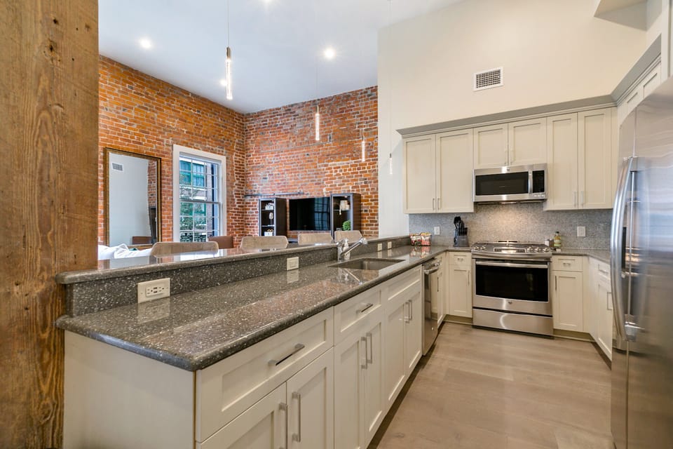 Cook and dine easily in the fully stocked kitchen, equipped with all stainless steel appliances, gas range, basic cookware, and a dining area for a comfortable meal at home. Entertain at the bar with seating for four.