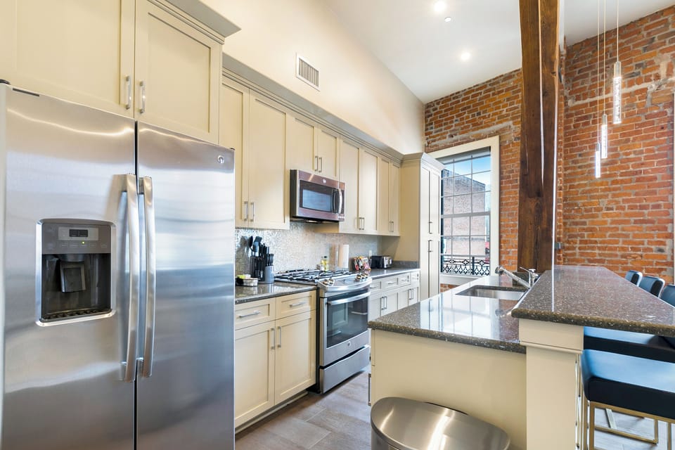 Cook and dine easily in the fully stocked kitchen, equipped with all stainless steel appliances, gas range, basic cookware, and a dining area for a comfortable meal at home. Entertain at the island with seating for four.