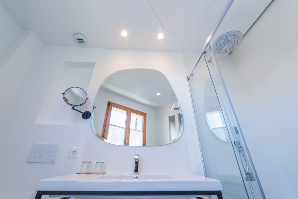 Shower, rainfall showerhead, hair dryer, towels