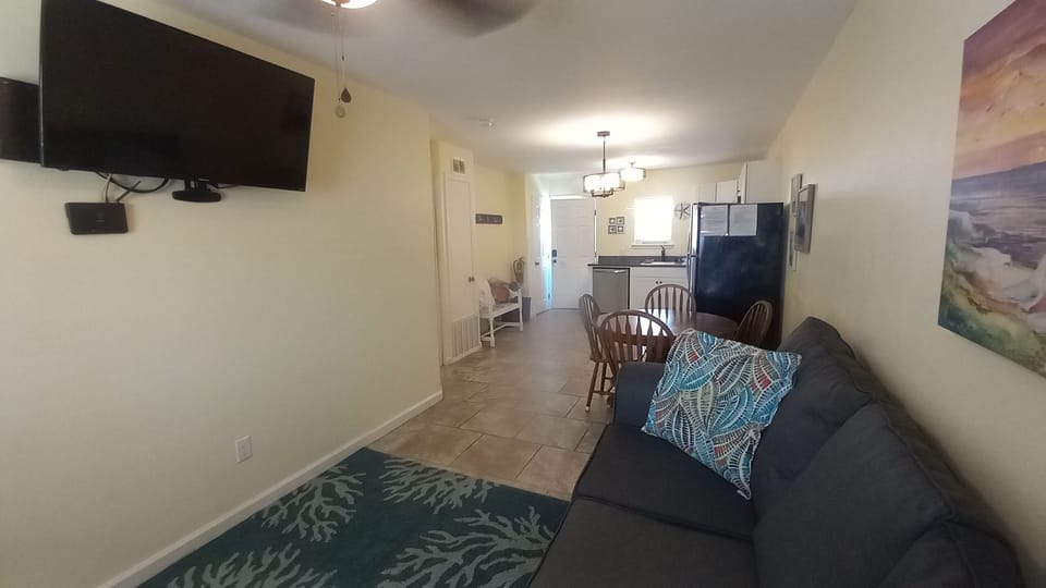 Living room with smart Tv and dining room