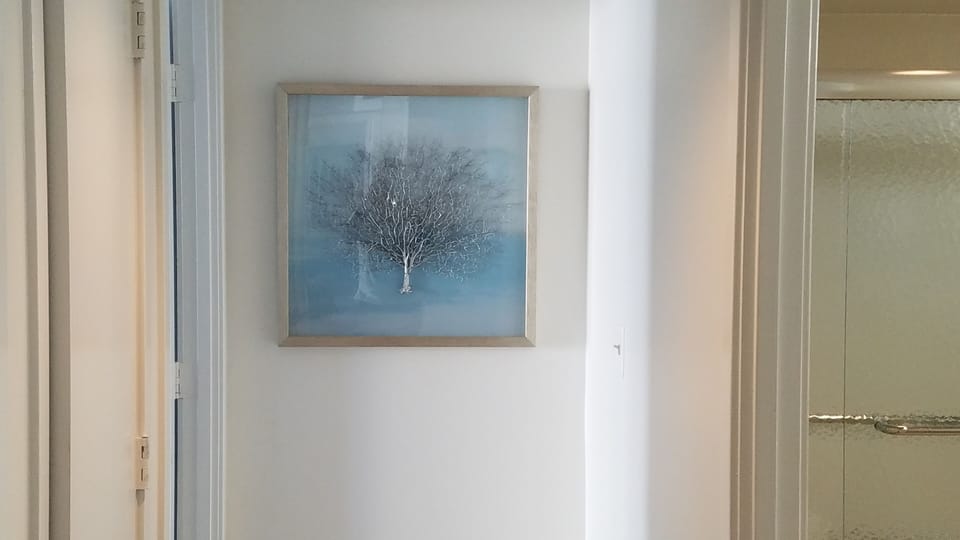 Stunning artwork at the end of the hallway. Guest bath to the right!