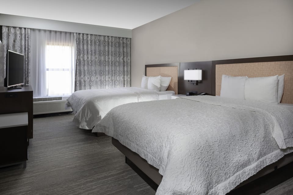 Premium bedding, desk, laptop workspace, blackout drapes