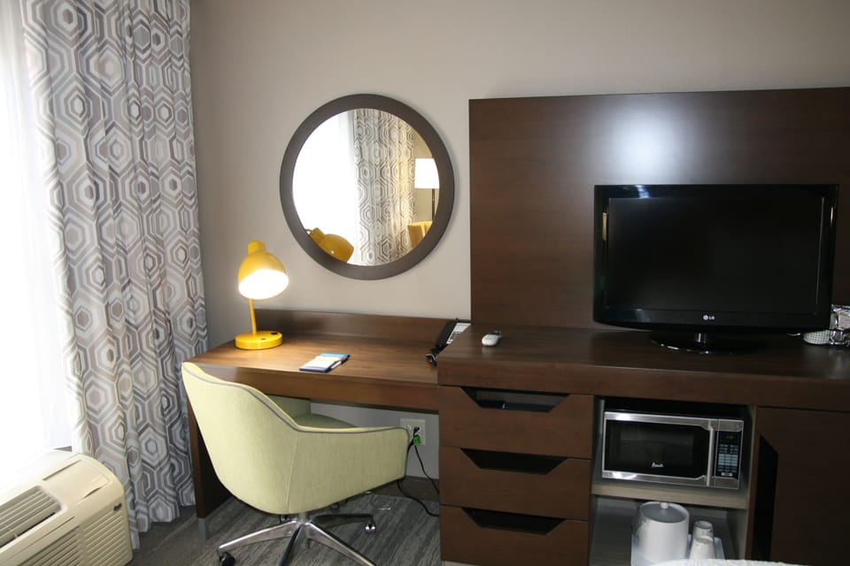 Premium bedding, desk, laptop workspace, blackout drapes
