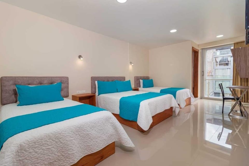 Deluxe Quadruple Room | Desk, laptop workspace, iron/ironing board (on request), WiFi (free)