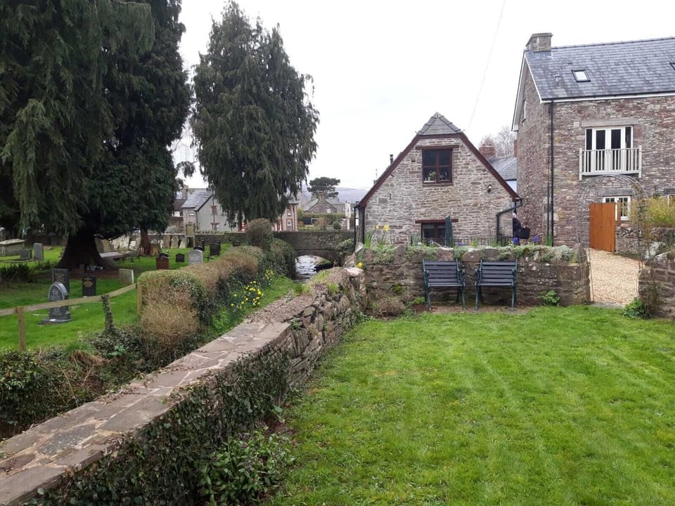 The private garden over the brook  with its view to the barn.