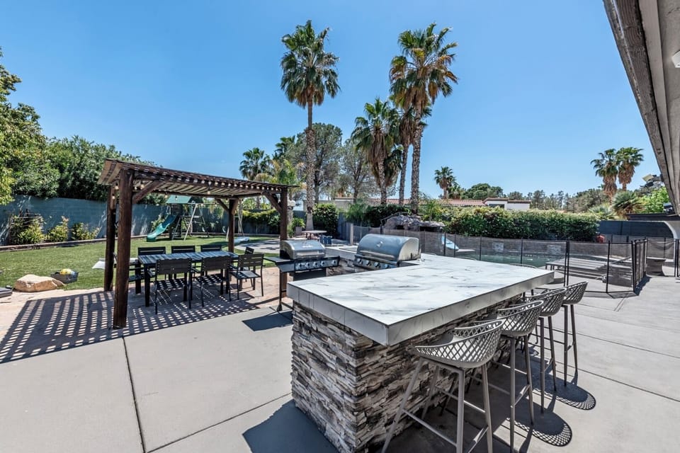 Bbq island with grill, mini fridge, outdoor dining and gazebo