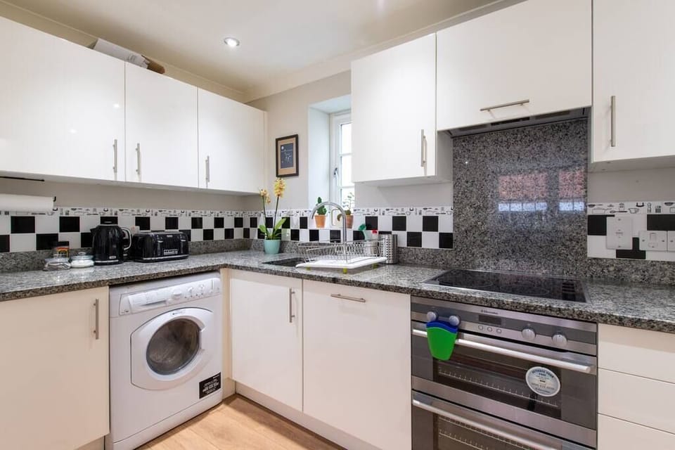 The kitchen with a washing machine.