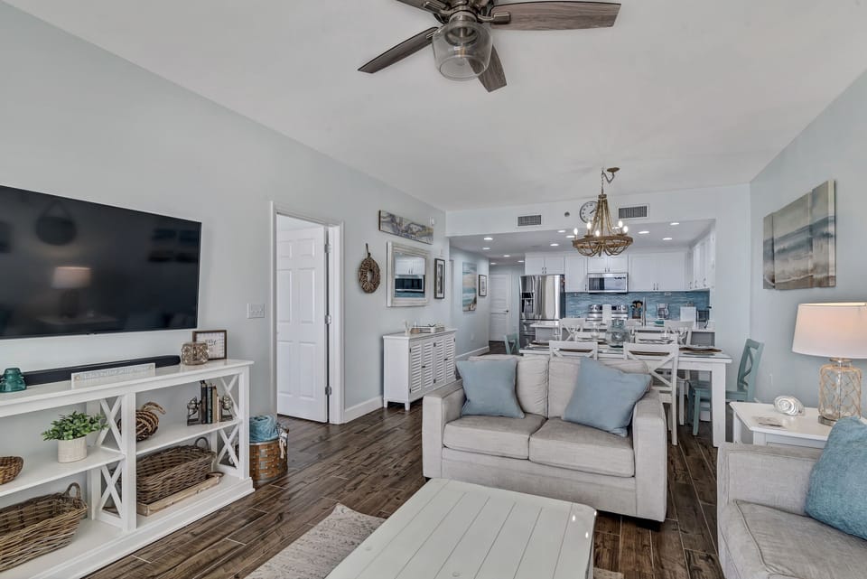 A comfortable living room with ample seating, flowing into a dining area, ideal for everyday living and gatherings.