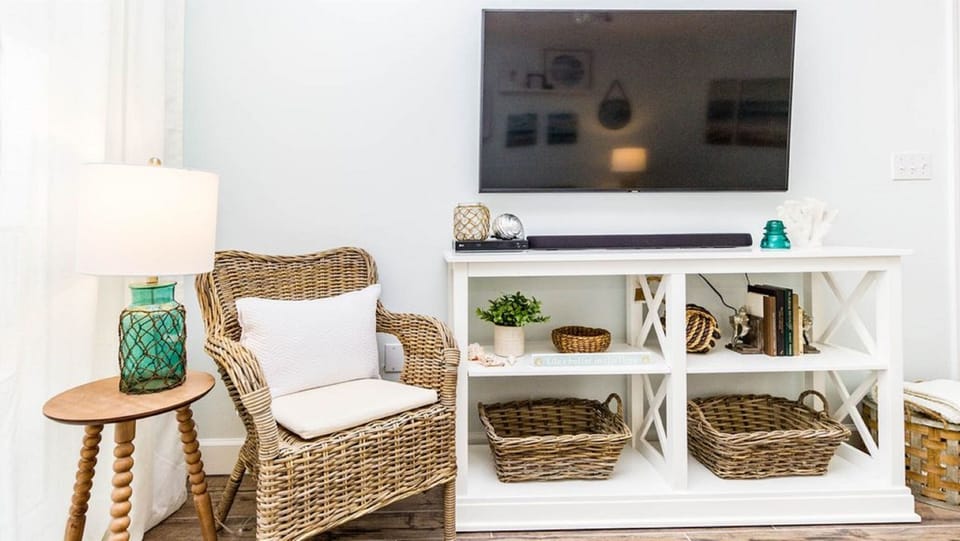 Natural textures and soft patterns create a serene and inviting corner, perfectly positioned to enjoy the expansive ocean views.