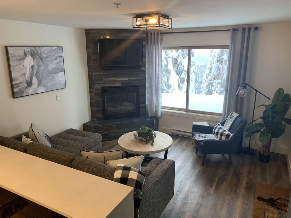 Living Room with Gas Fireplace and Plenty of Light 
