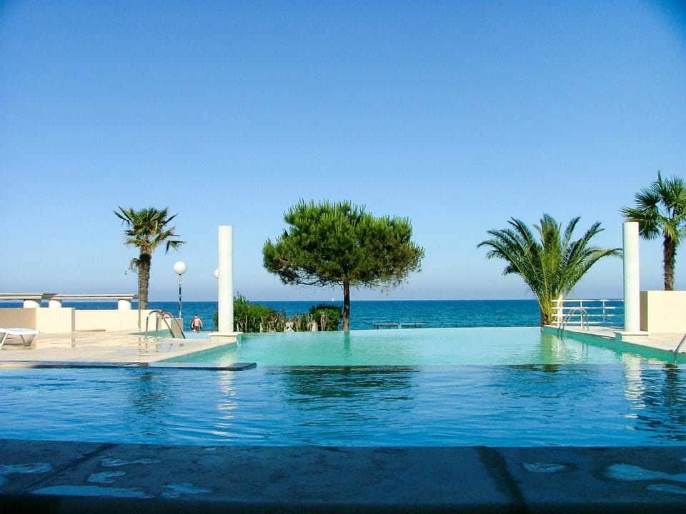 Water, Sky, Blue, Swimming Pool, Tree, Arecales, Plant, Shade, Outdoor Furniture, Leisure