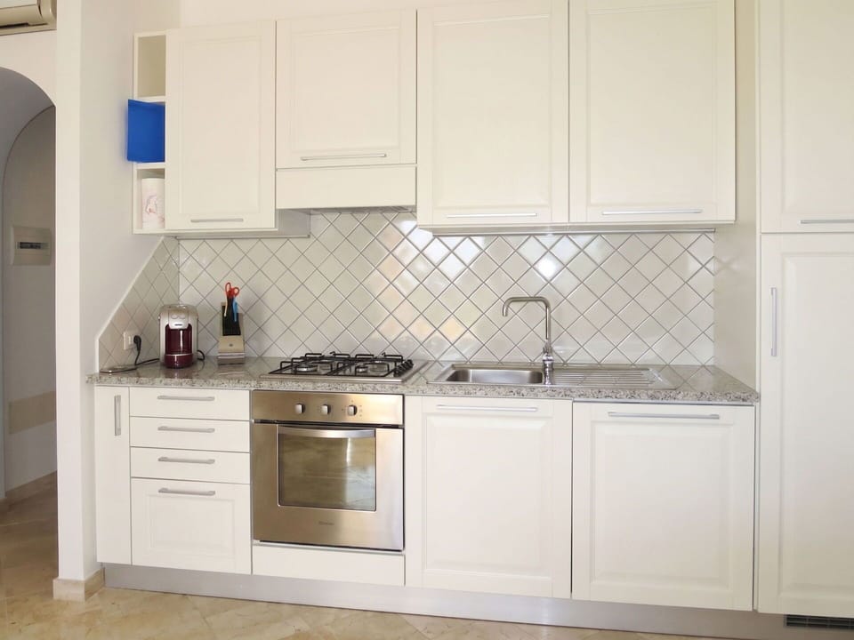 Kitchen, Countertop, Kitchen Appliance, Interior Design, Flooring, Major Appliance, Wood, Cabinetry, Stove, Kitchen Stove