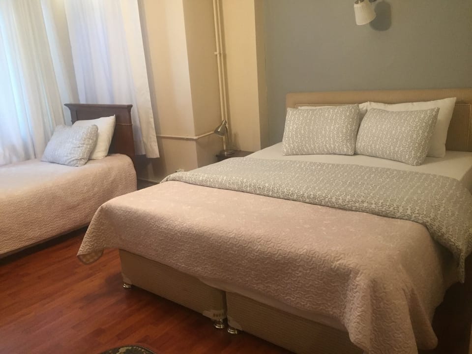 Family Triple Room | Premium bedding, iron/ironing board, free WiFi, bed sheets
